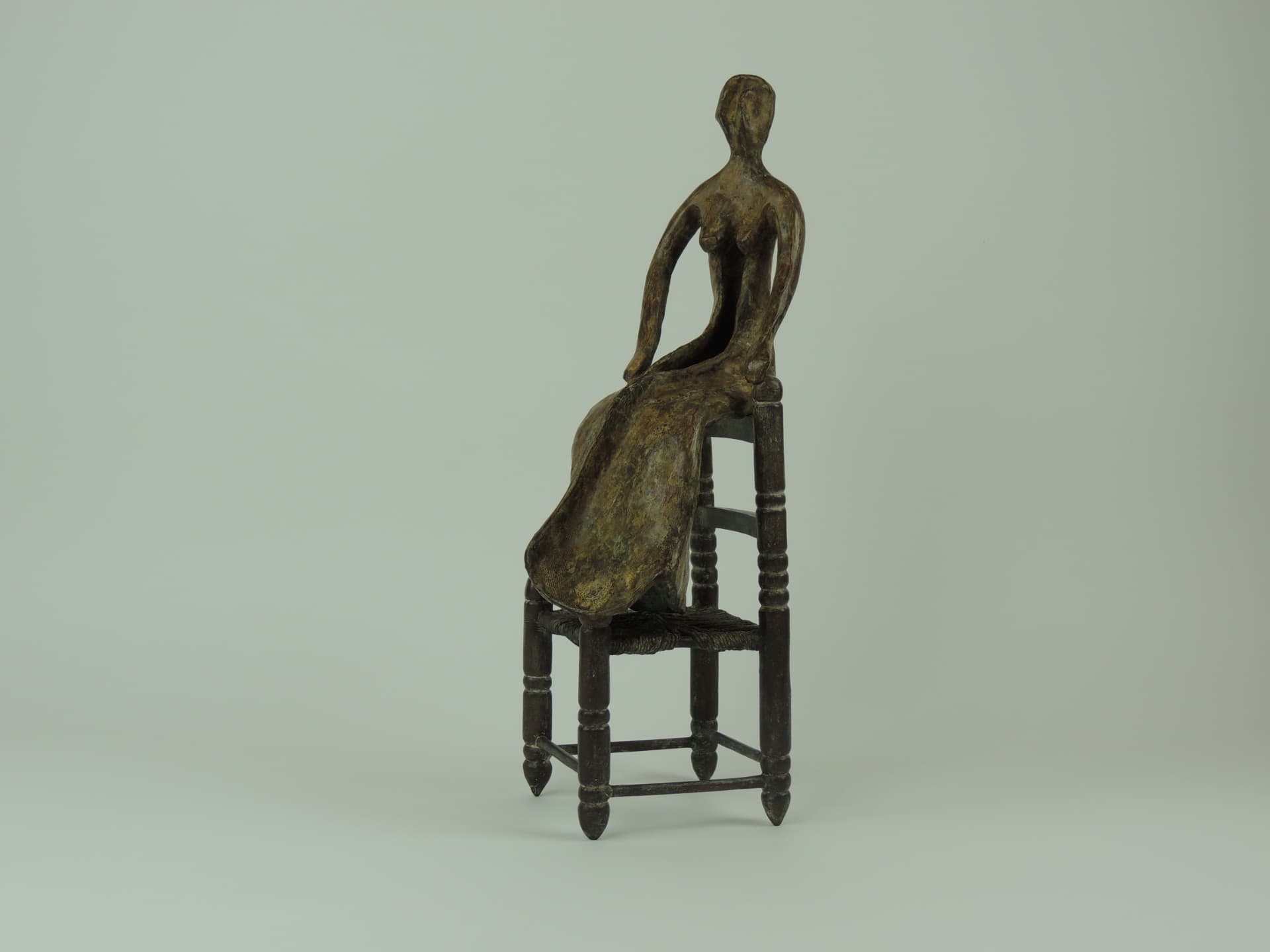 Woman on a Chair, bronze — three-quarter view