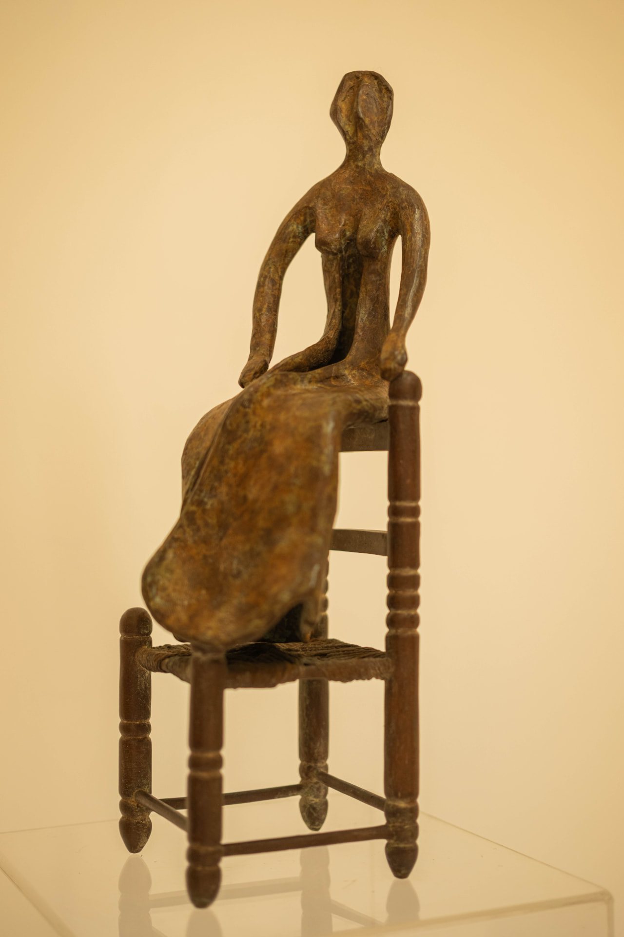 Woman in a Straw Chair, bronze sculpture