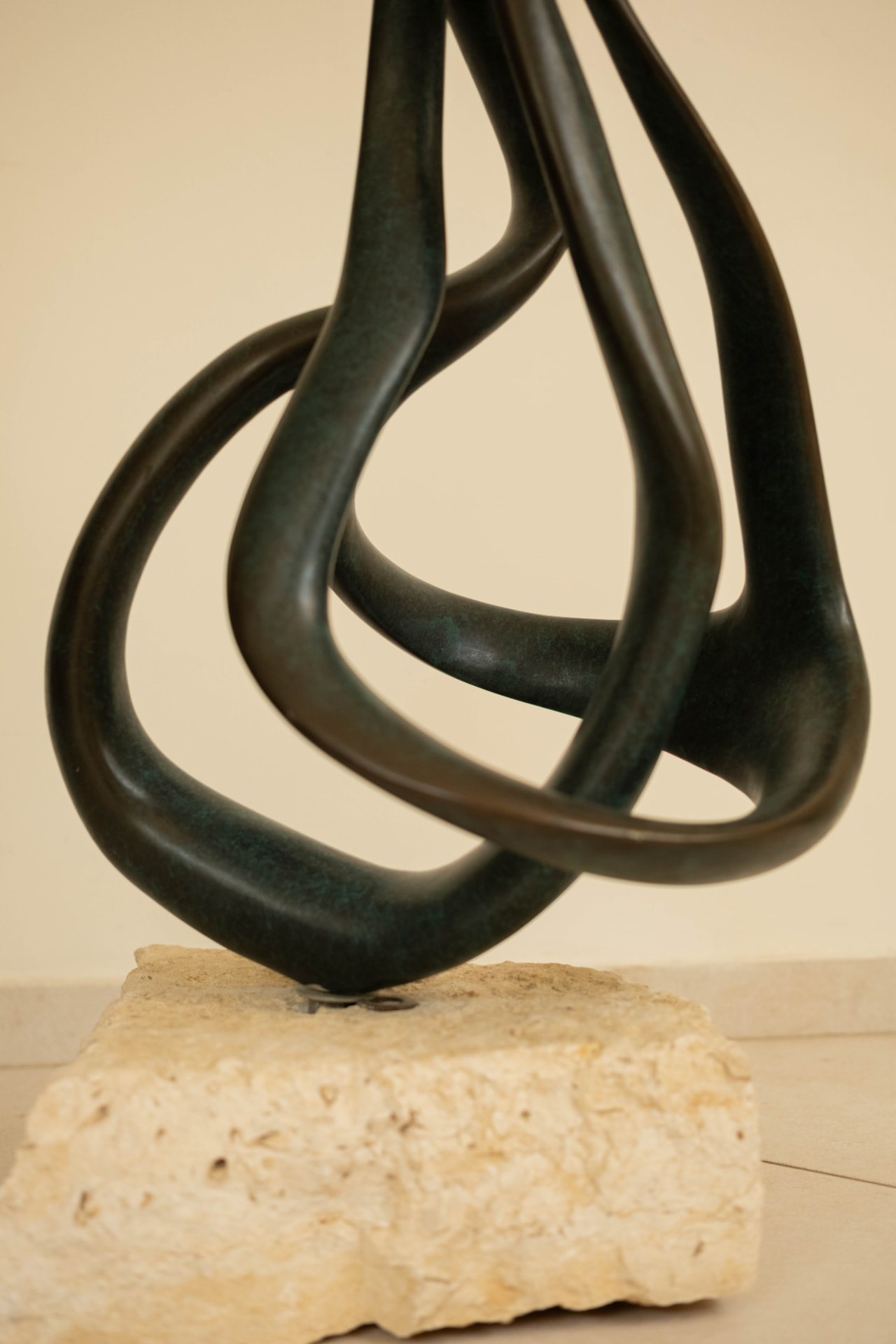 Ribbon — abstract bronze sculpture on a stone base