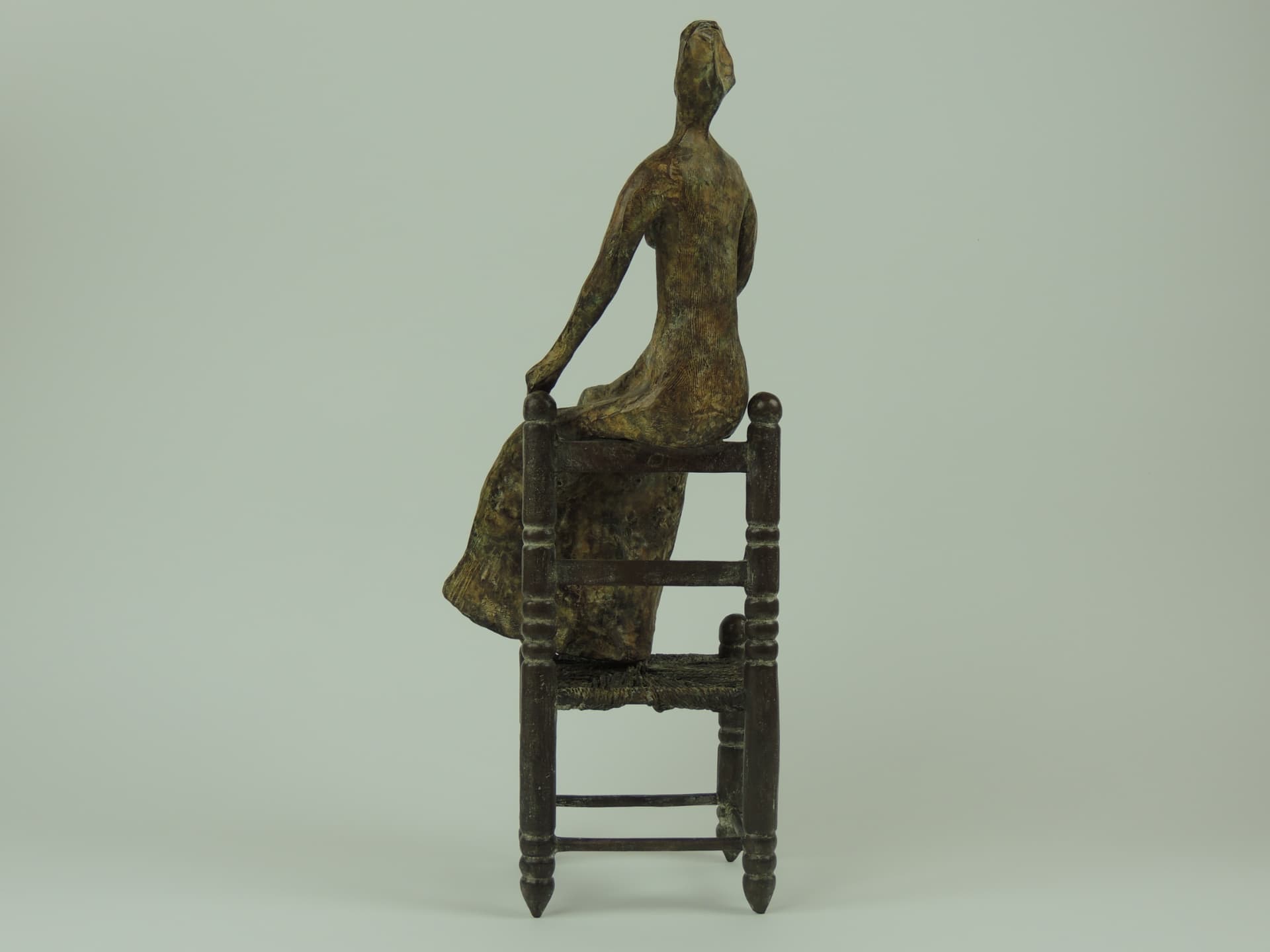 Woman on a Chair, bronze — rear side view