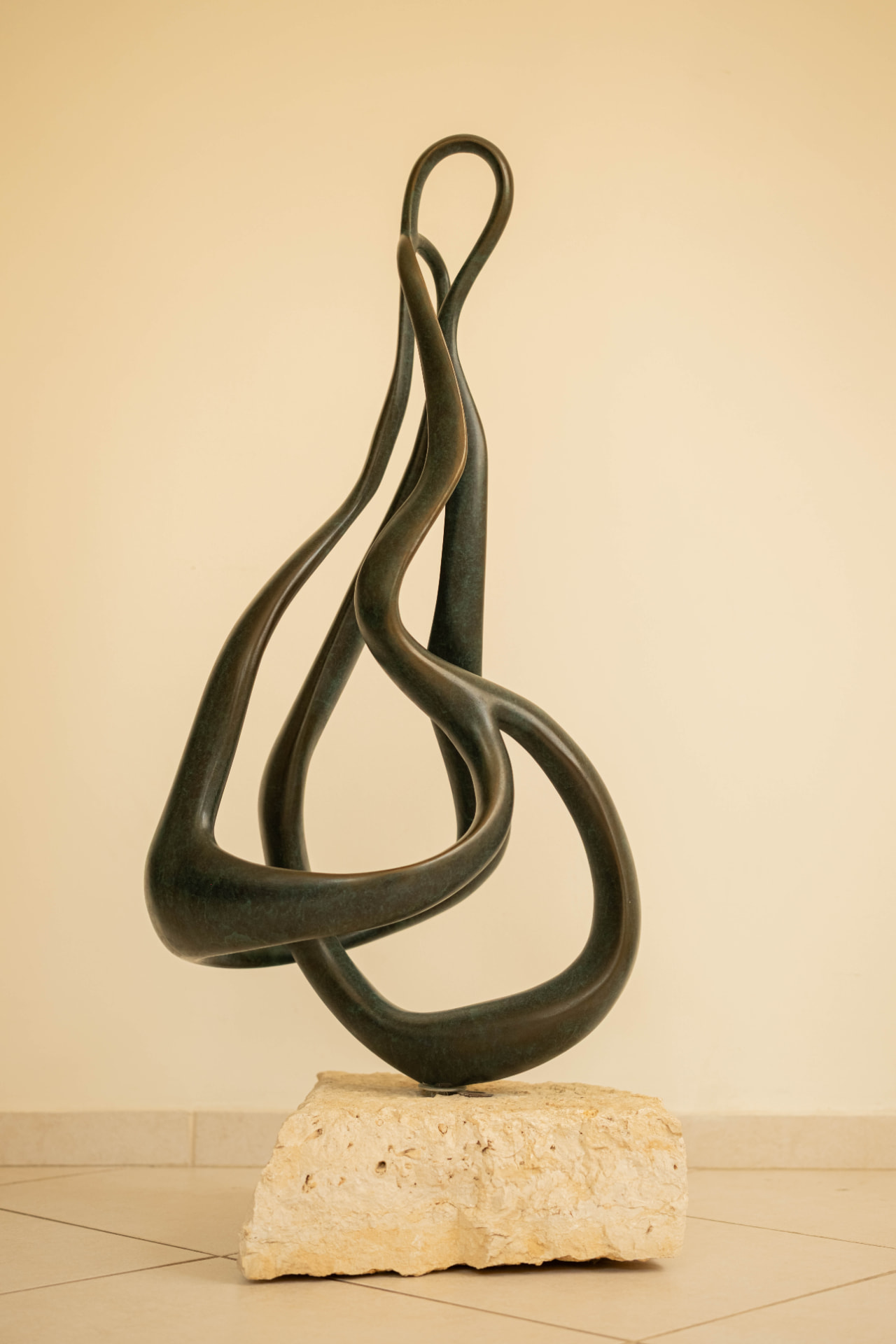 Ribbon — abstract bronze sculpture on a stone base