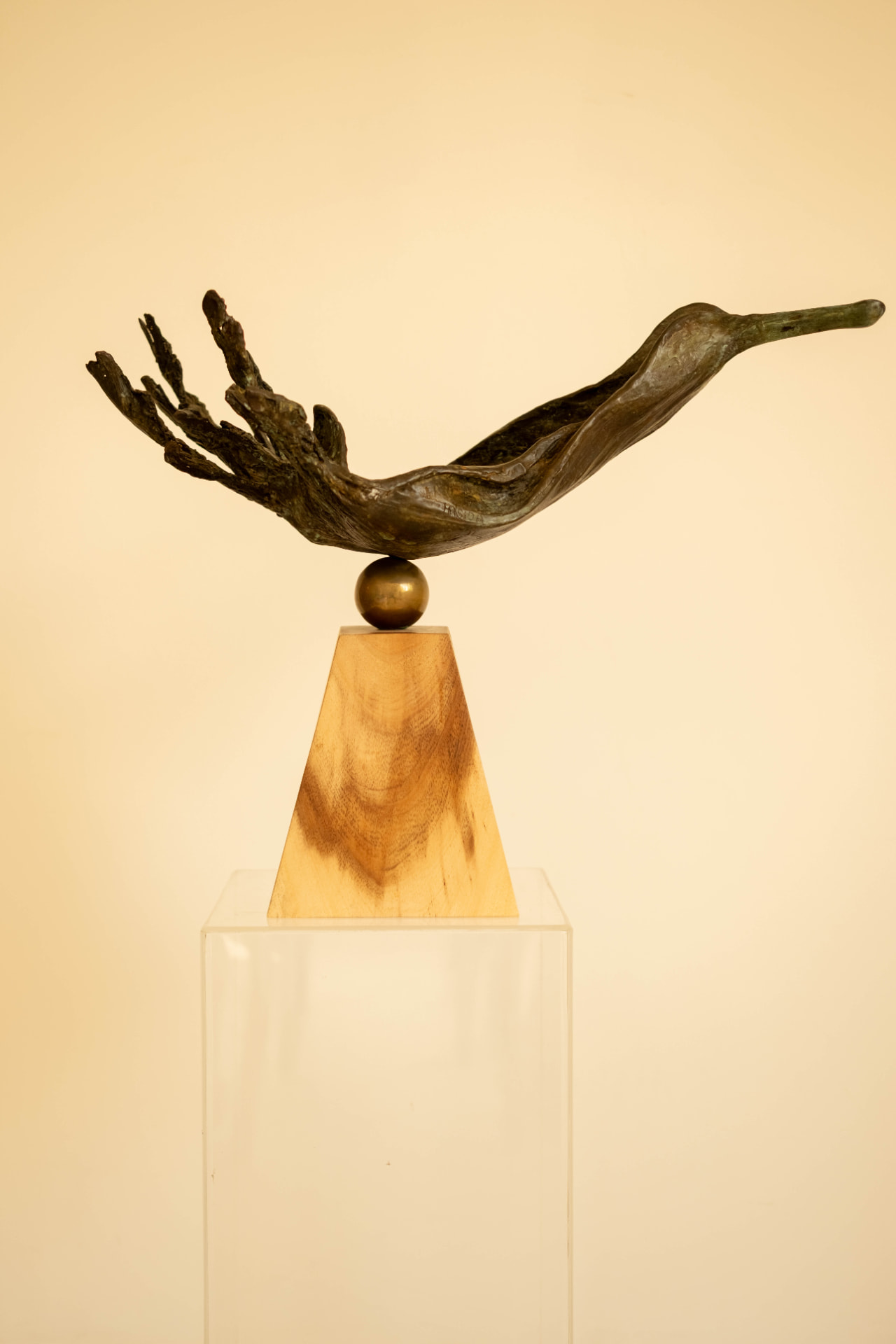 Wave Bird — bronze sculpture balanced on a brass sphere