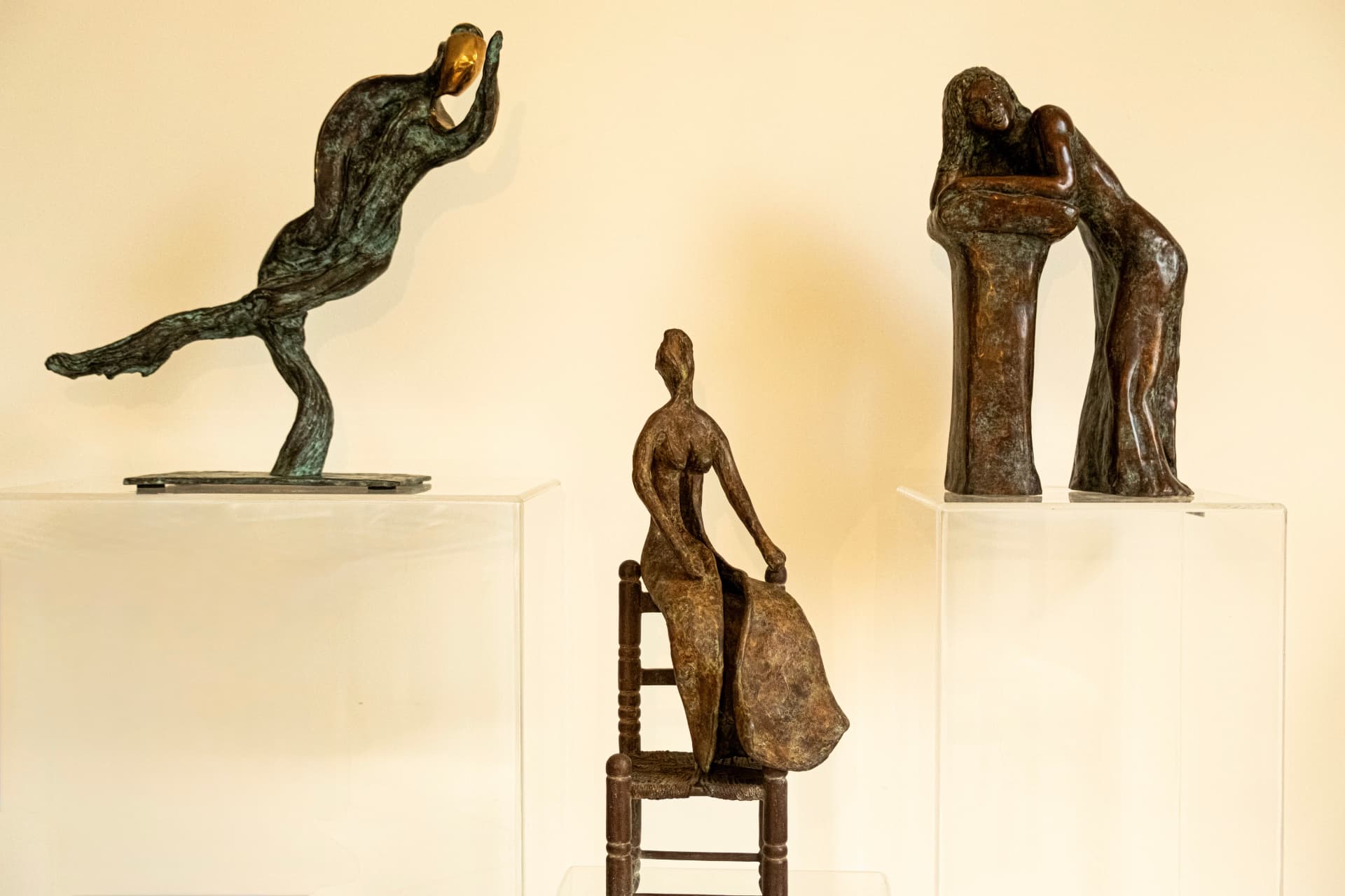 Three bronze sculptures by Hasida Steinbock displayed together on plinths in the studio