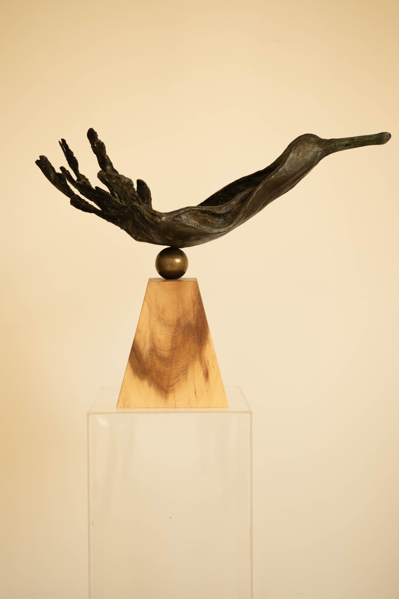 Wave Bird — bronze sculpture balanced on a brass sphere