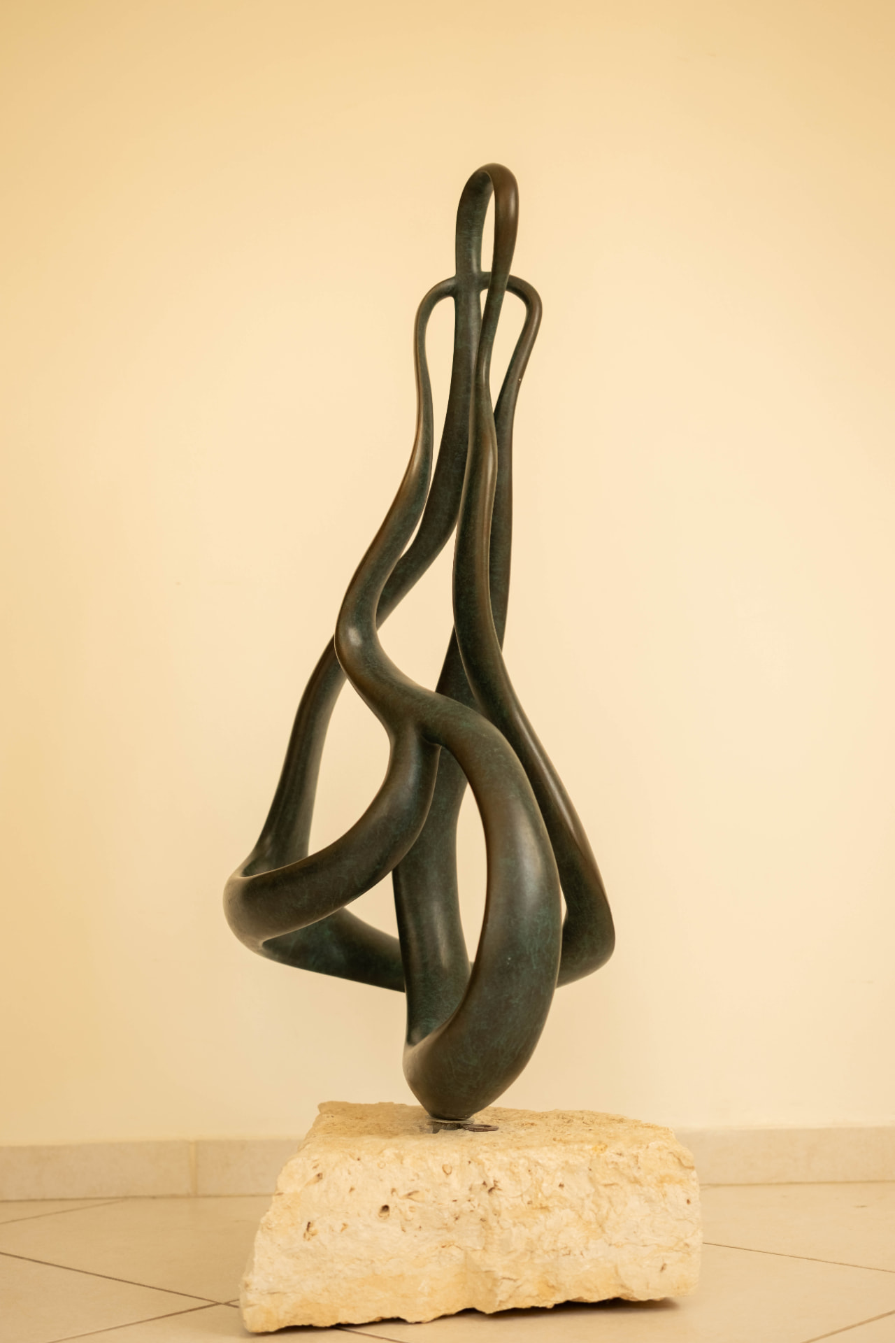 Ribbon — abstract bronze sculpture on a stone base