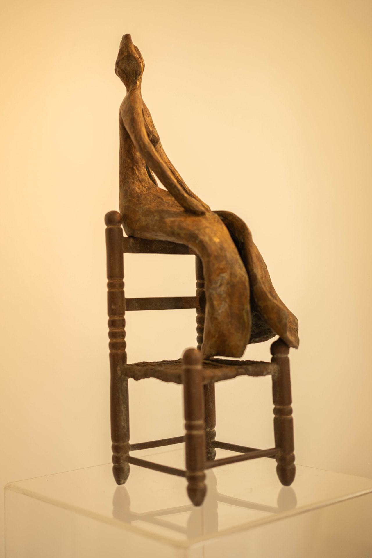 Woman in a Straw Chair, bronze sculpture