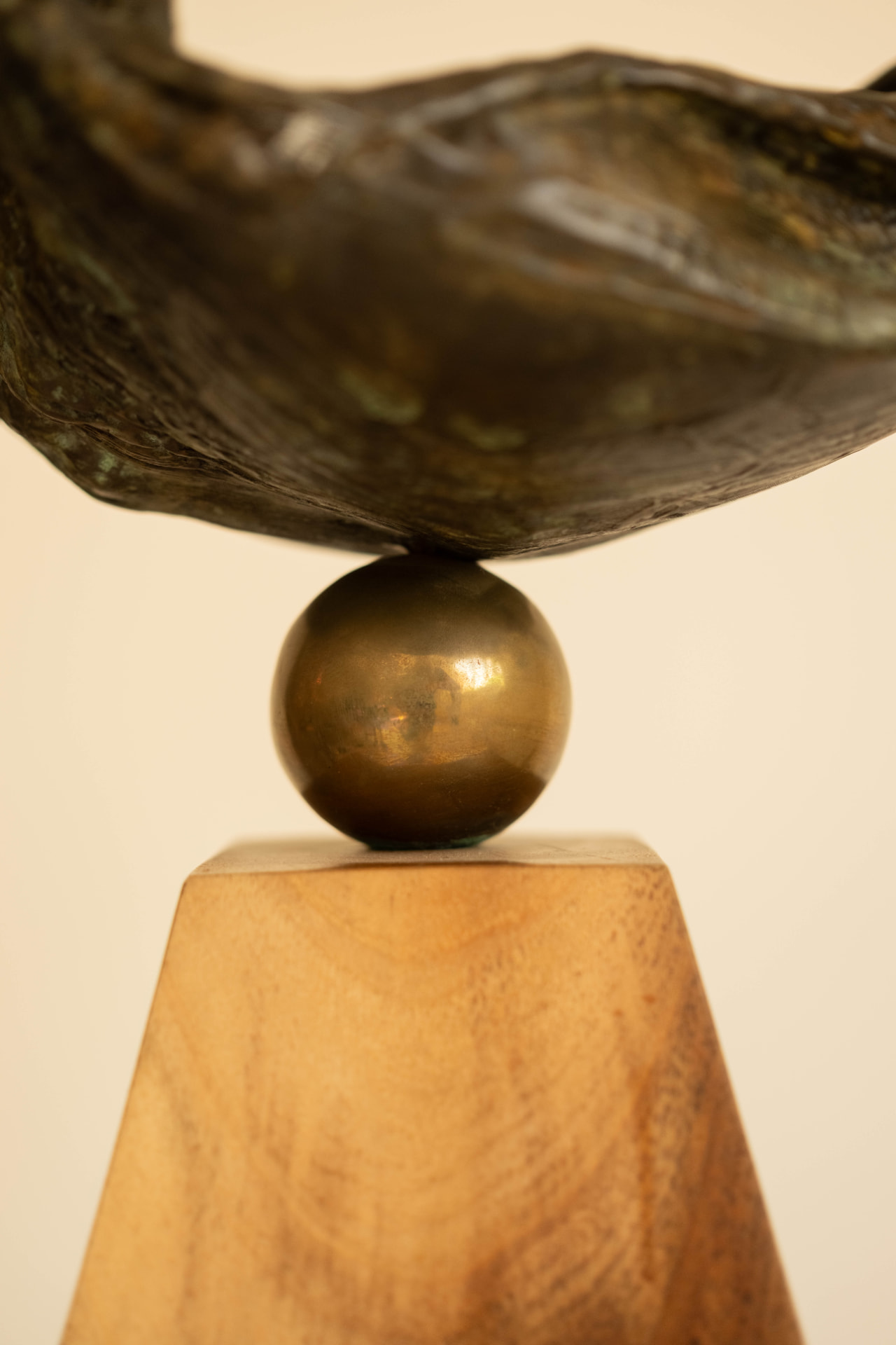 Wave Bird — bronze sculpture balanced on a brass sphere