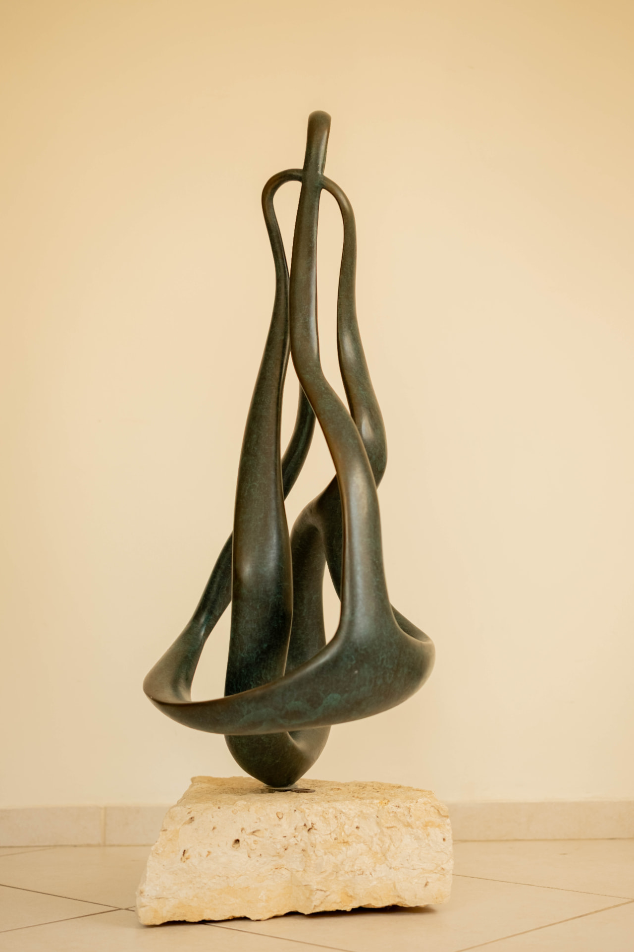 Ribbon — abstract bronze sculpture on a stone base