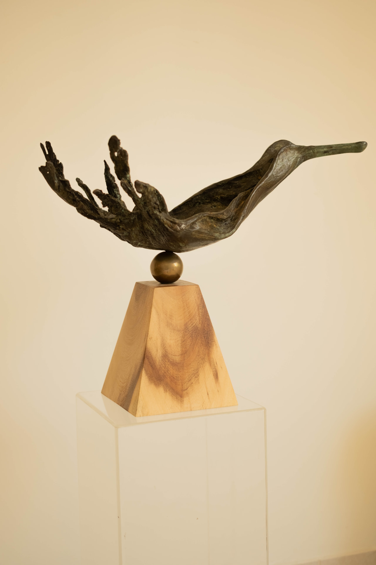 Wave Bird — bronze sculpture balanced on a brass sphere
