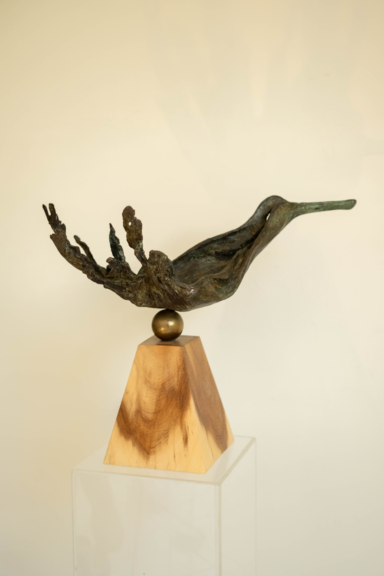 Wave Bird — bronze sculpture balanced on a brass sphere